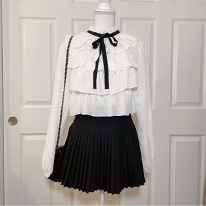White pussybow blouse with ruffles and black ribbon